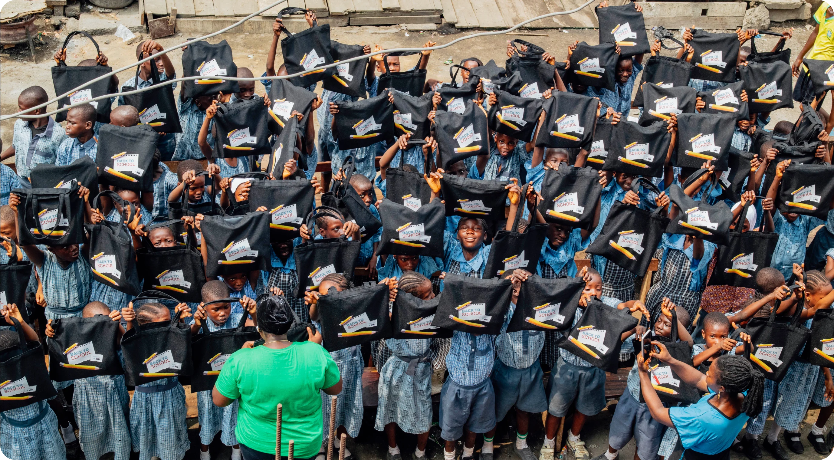 a group of people holding up bags